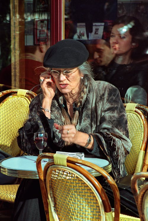 Elderly Woman in Sidewalk Cafe