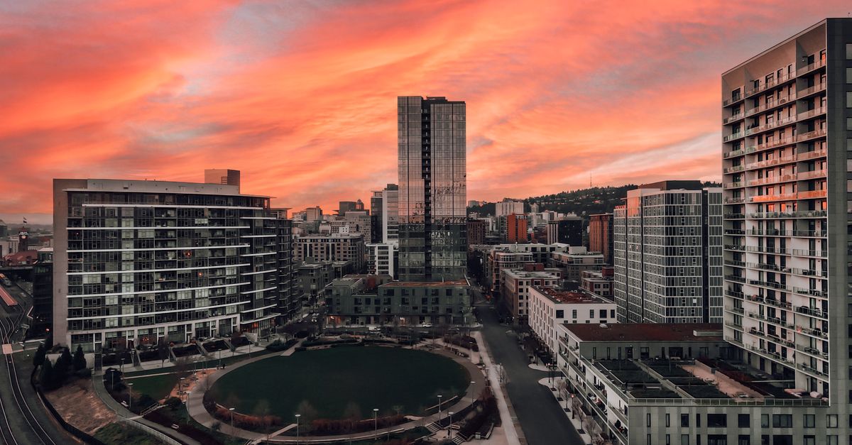 A stunning urban skyline view with a vibrant sunset sky, highlighting modern architecture.