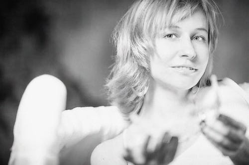 Crop smiling woman wearing angel wings in studio