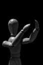 Grayscale Photo of Wooden Mannequin