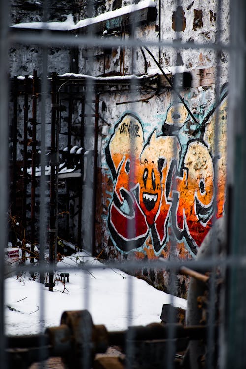 Blue Red and Orange Graffiti on Wall