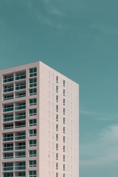 Contemporary multistory building with balconies under a clear blue sky in Aruba.