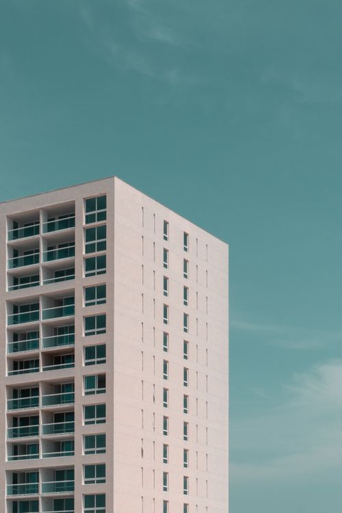 Free Contemporary multistory building with balconies under a clear blue sky in Aruba. Stock Photo