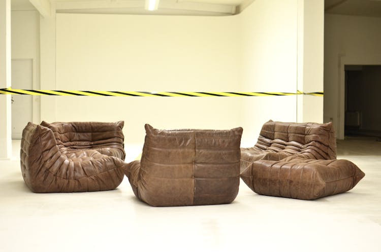 Comfy Sofas In Empty Room With Restriction Tape