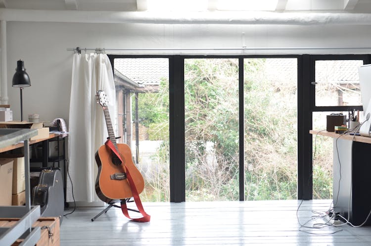 Interior Of Room For Musician With Guitar On Stand