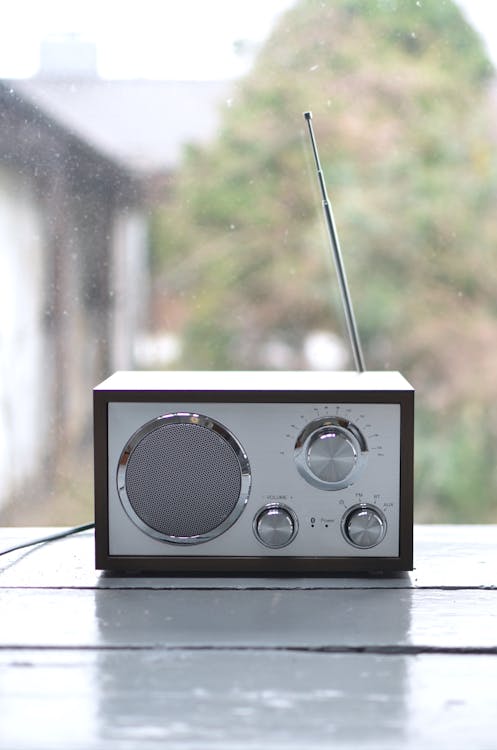 Small retro radio set on wooden windowsill
