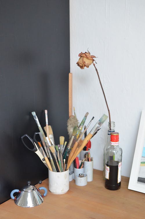 Artist workspace with various paintbrushes and stationery