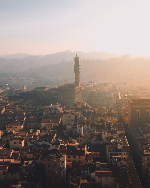 Free Stunning aerial shot of Florence, Italy, with a warm sunset illuminating historic architecture. Stock Photo