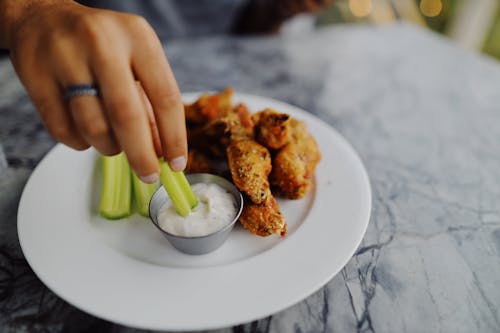 Free Person Dipping Celery on a Ranch Dip Stock Photo