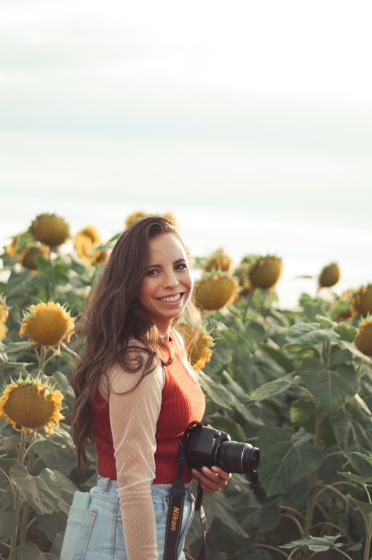 Happy Photographer Standing In Sunflower Field