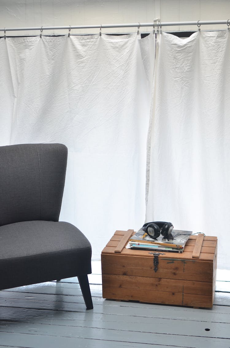 Armchair And Chest With Magazines In Modern Room