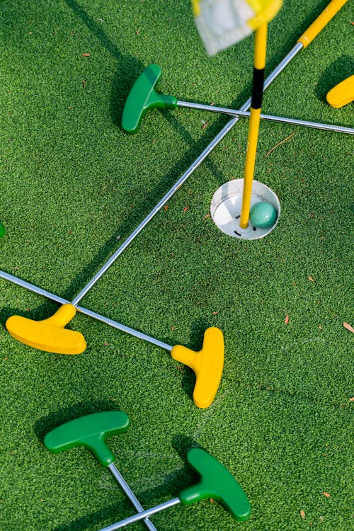 Green and Yellow Putters on Green Grass