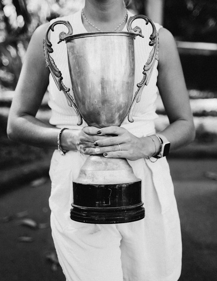 A Person Holding A Trophy