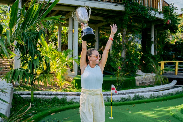 A Woman Holding A Trophy