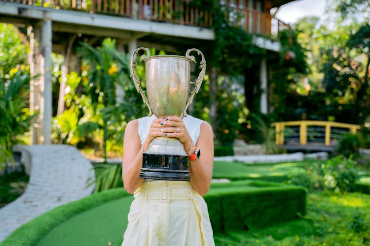 A Woman Holding A Trophy