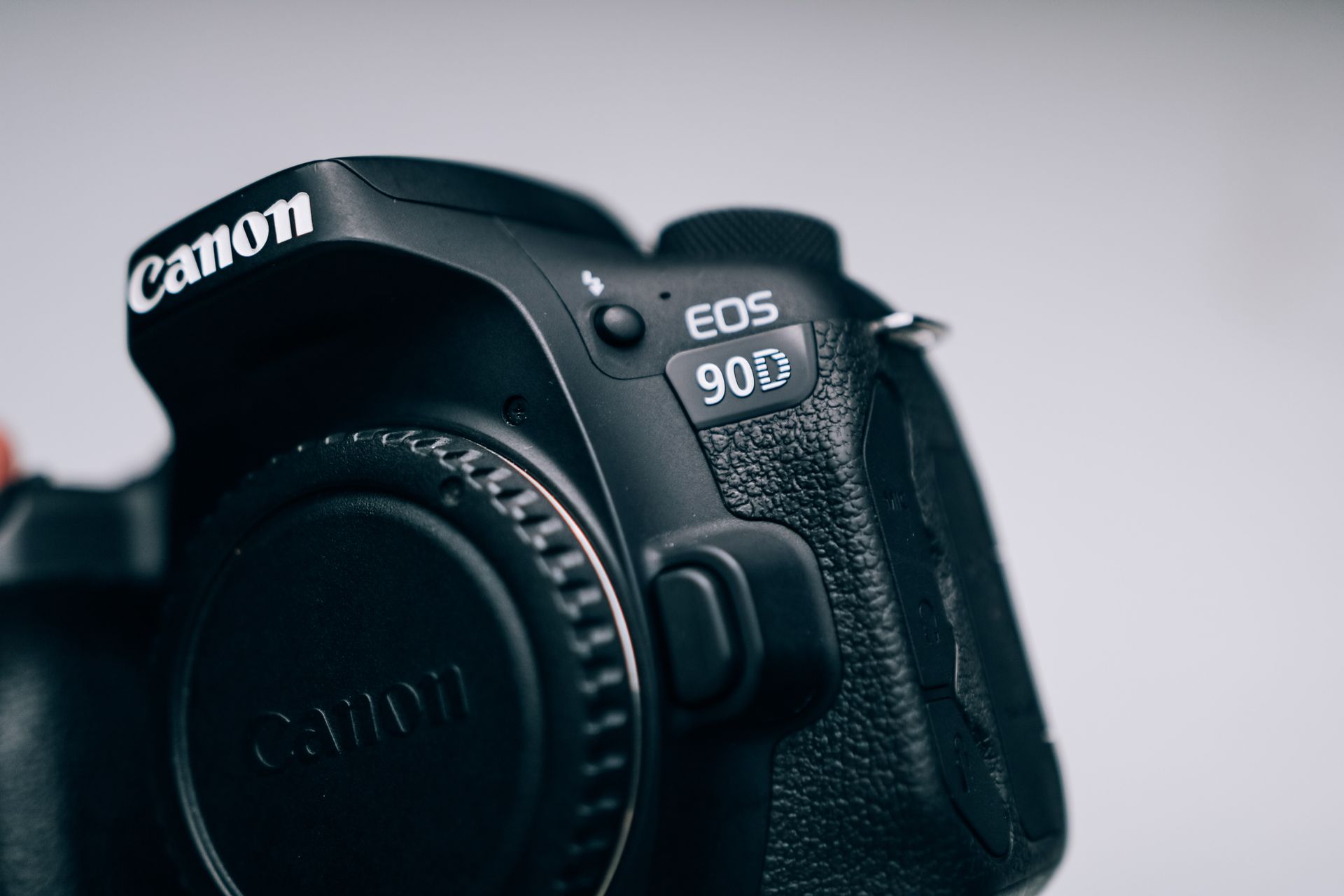 Detailed close-up image of a DSLR camera body showcasing fine textures and model features.