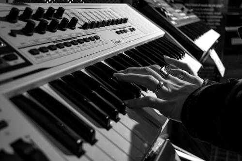無料 グレースケール写真でエレクトリックピアノを弾く人 写真素材