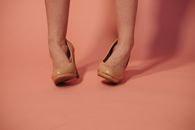 A Woman Wearing Brown High Heels Twisting her Ankles