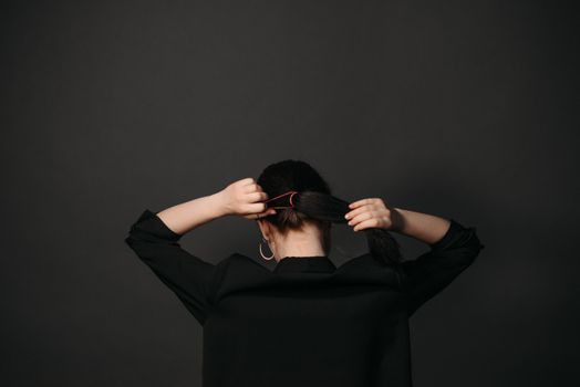A Woman Tying Her Hair With a Hair Band