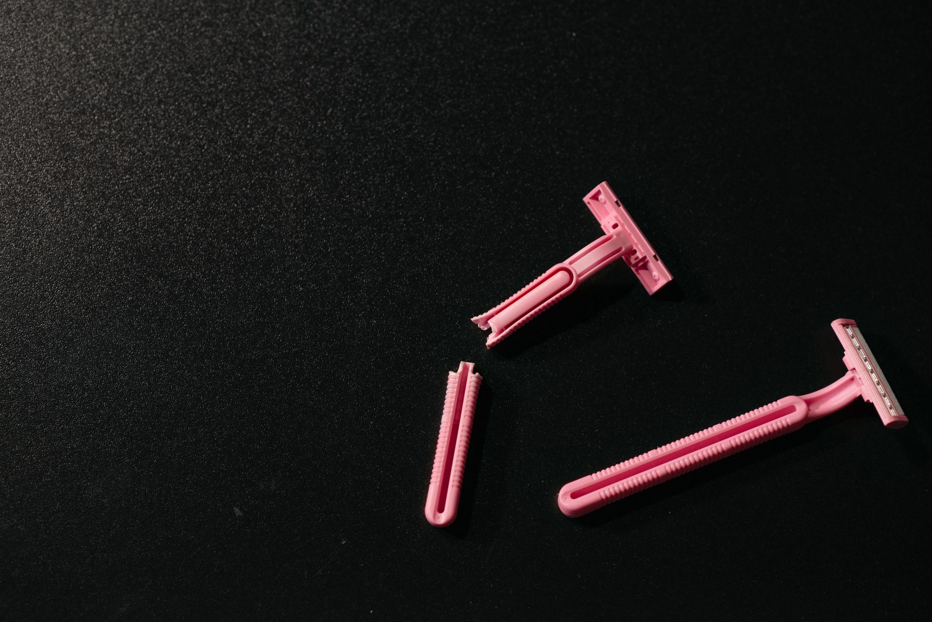 Razors over a Black Surface