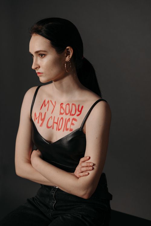 Free Studio portrait of a woman with 'My Body My Choice' written on her chest, embodying empowerment. Stock Photo
