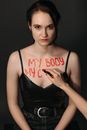 A Woman Putting a Worded Statement on Her Chest