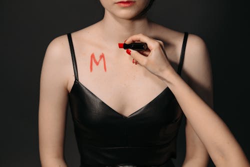Free A Person Writing using a Red Lipstick on a Woman's Body  Stock Photo