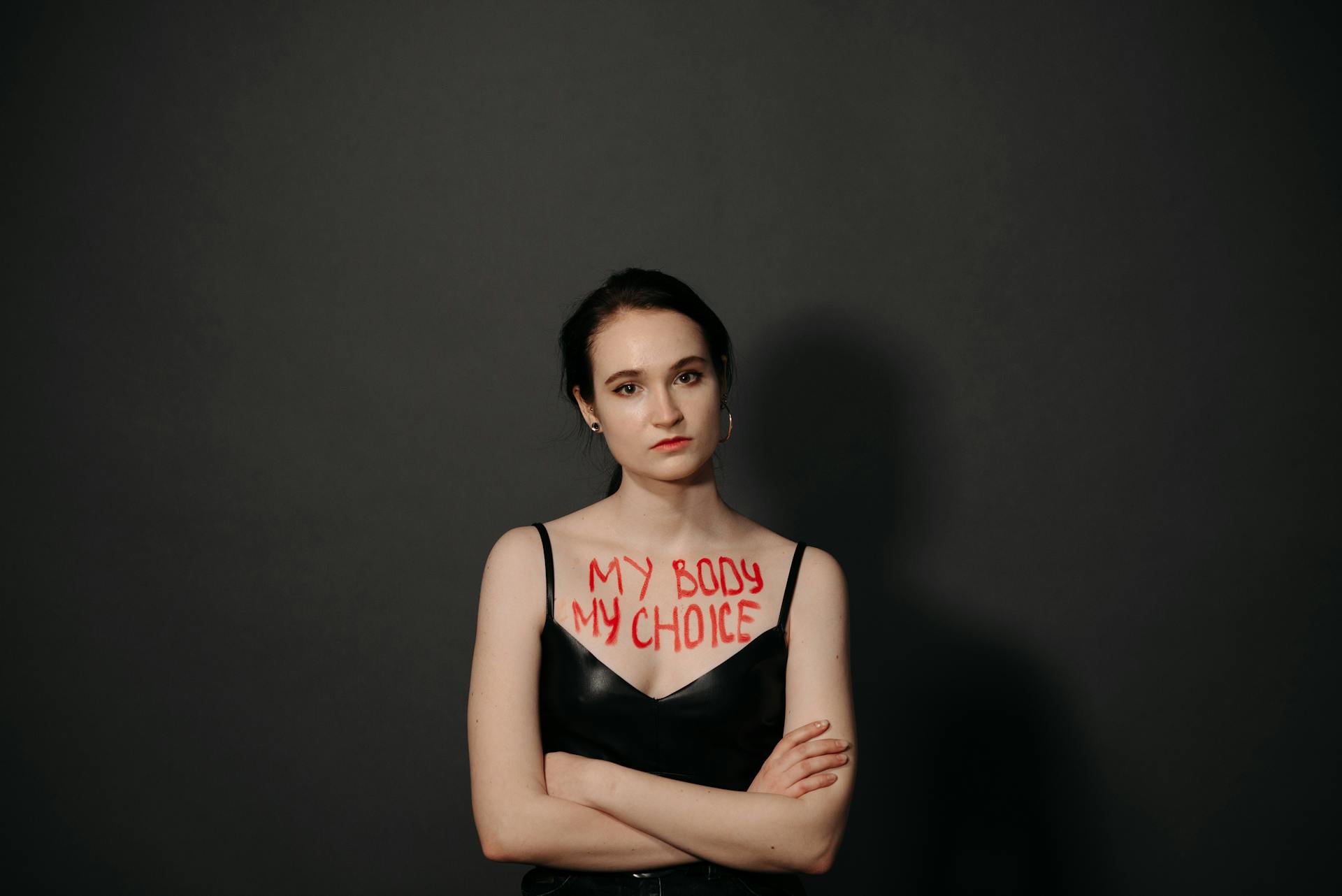 Woman standing confidently with 'My Body My Choice' message, empowering feminism and body positivity.