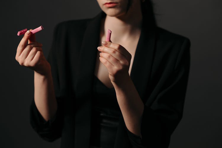 Woman In Black Blazer Holding Pink Broken Razor