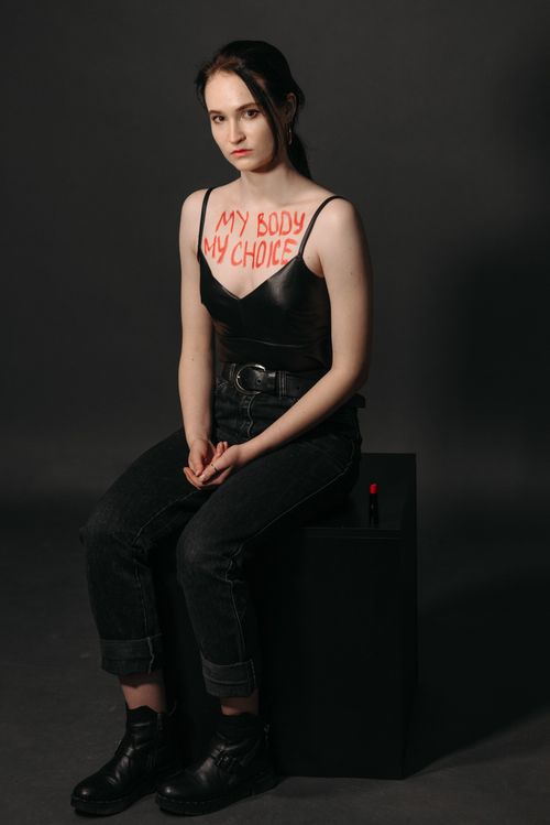 Free Studio portrait of a woman with 'My Body My Choice' written on her chest, advocating freedom of choice. Stock Photo