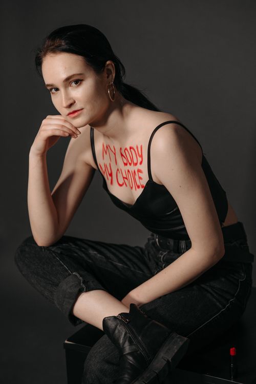 Free Confident woman posing with 'My Body My Choice' written on her chest, advocating for women's rights. Stock Photo
