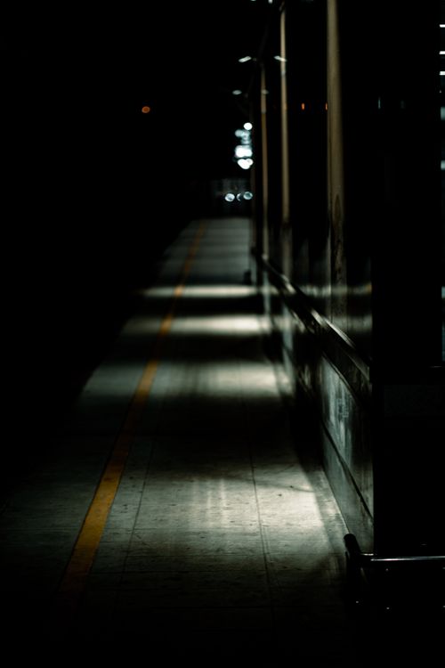 Free Dark and moody view of an empty subway platform at night, highlighting urban solitude. Stock Photo