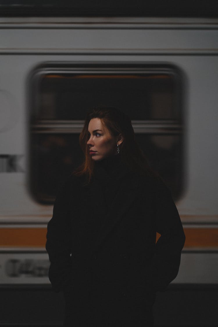 Woman Posing On Platform In Front Of Train 