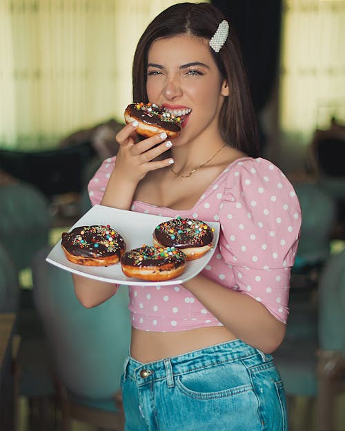 A Woman Eating Chocolate Donut