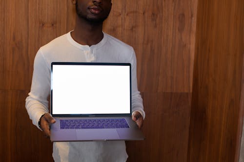Free A Man Holding a Laptop Stock Photo