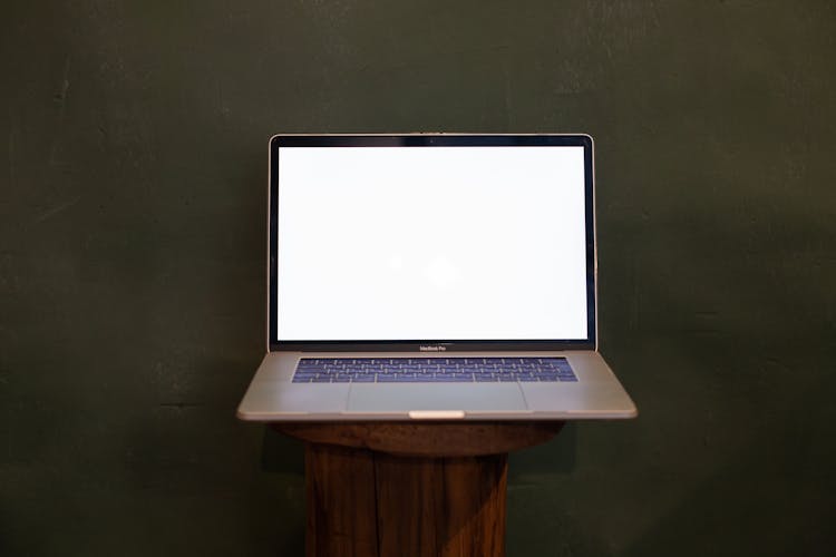 Laptop With Mockup Screen On Table On Green Background