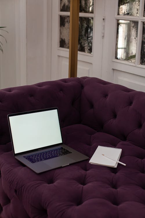 Free A Laptop on a Couch Stock Photo