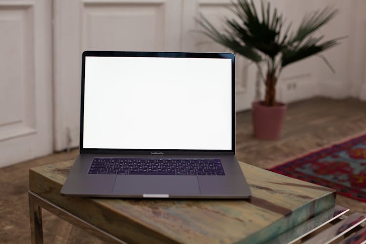 Laptop With Blank Screen On Table At Home