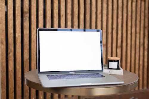 Laptop Displaying a Blank White Screen Standing on a Coffee Table