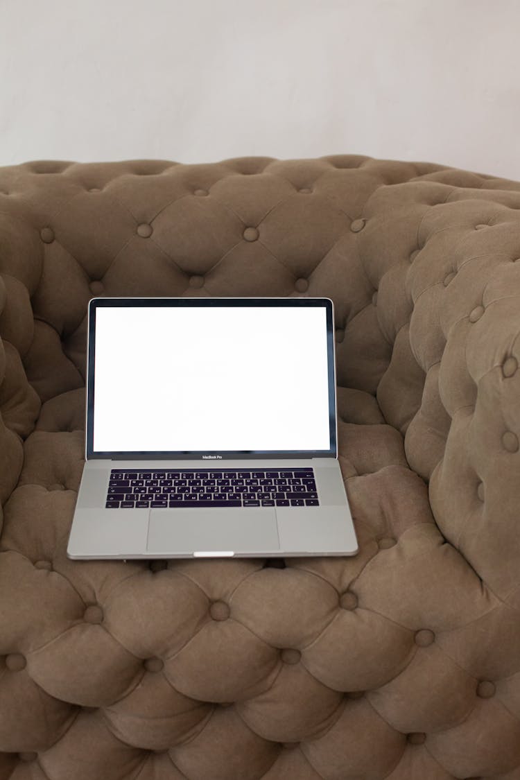 Laptop With Blank Screen On Sofa Indoors