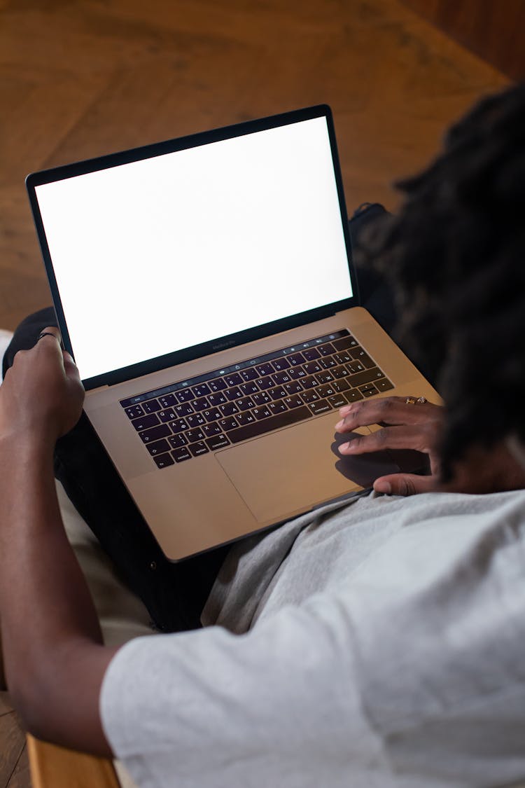 Over The Shoulder View Of A Man Using A Laptop