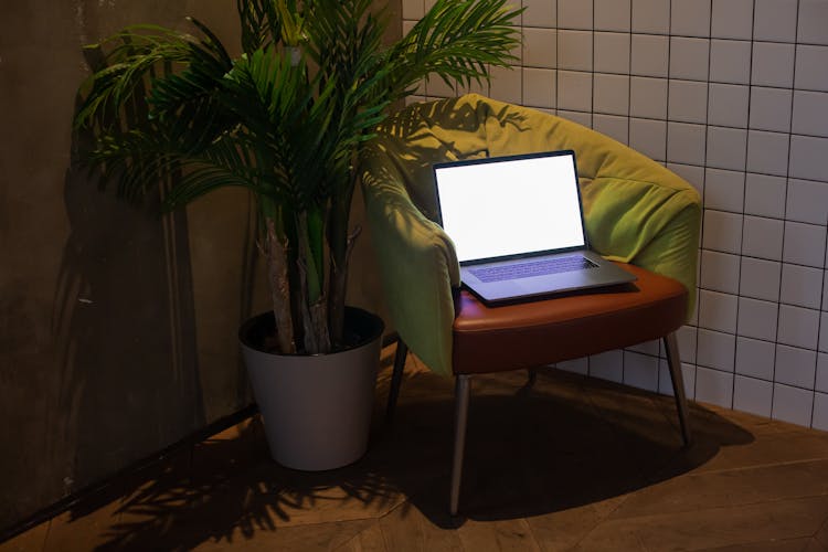 Open Laptop With Mockup Screen On Chair 