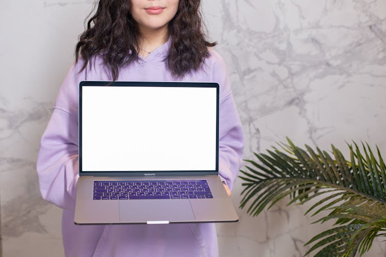 Woman Holding Laptop With White Screen