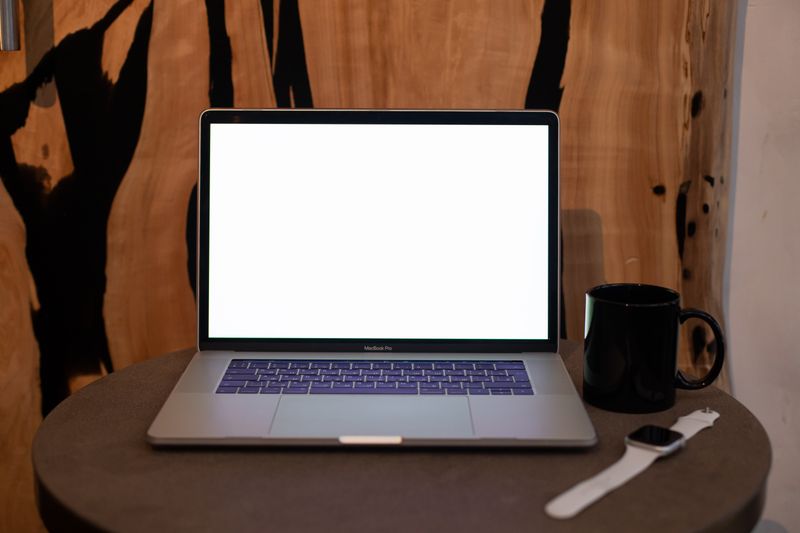 Contemporary workspace with an open laptop and notebook — photo by KATRIN BOLOVTSOVA on Pexels