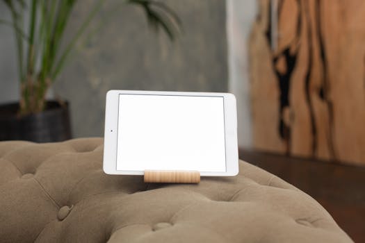 Close-up view of a digital tablet on a sofa, perfect for design mockups or gadget showcases.