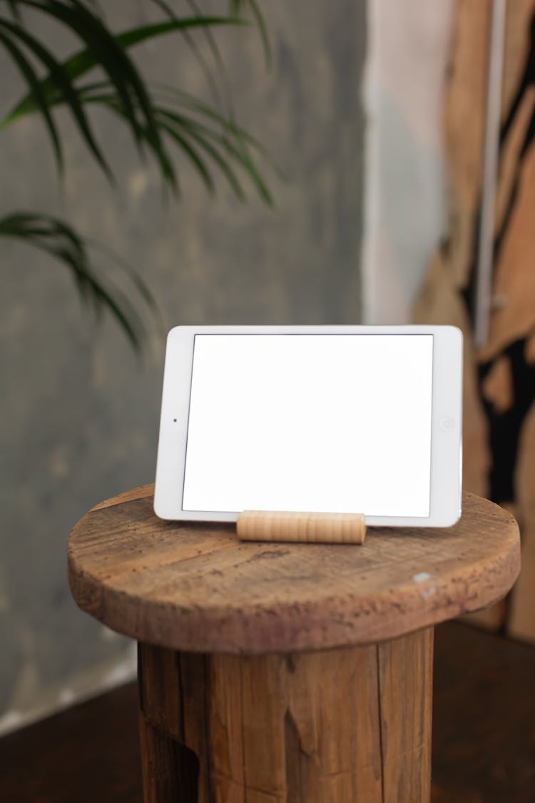 A Tablet With A Blank Screen On A Wooden Bar Stool
