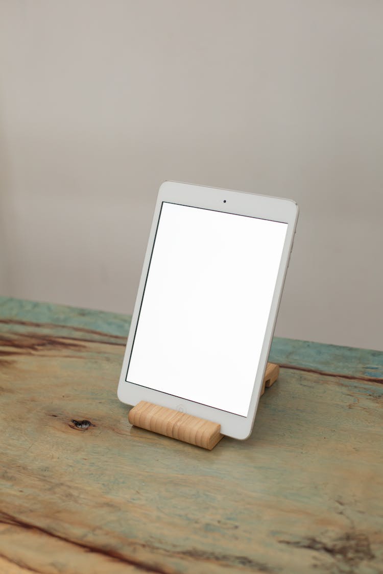 A Tablet With A Blank Screen On A Bamboo Tablet Stand
