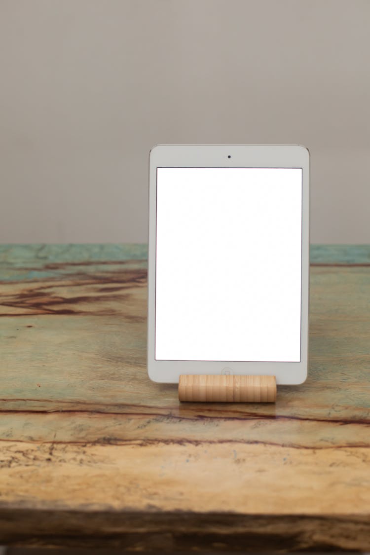 A Tablet With A Blank Screen On A Bamboo Tablet Stand
