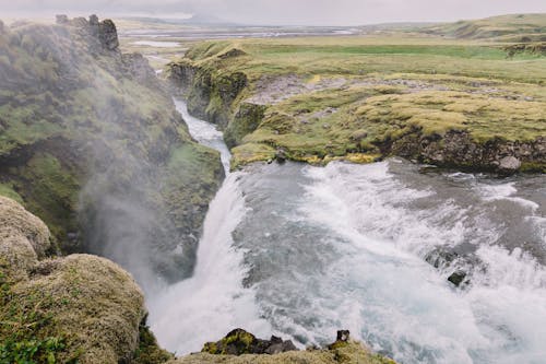 Water Falls Cascading on a Mossy Cliff