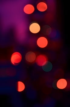 Vibrant bokeh circles in red and pink hues create a dreamy and abstract visual.